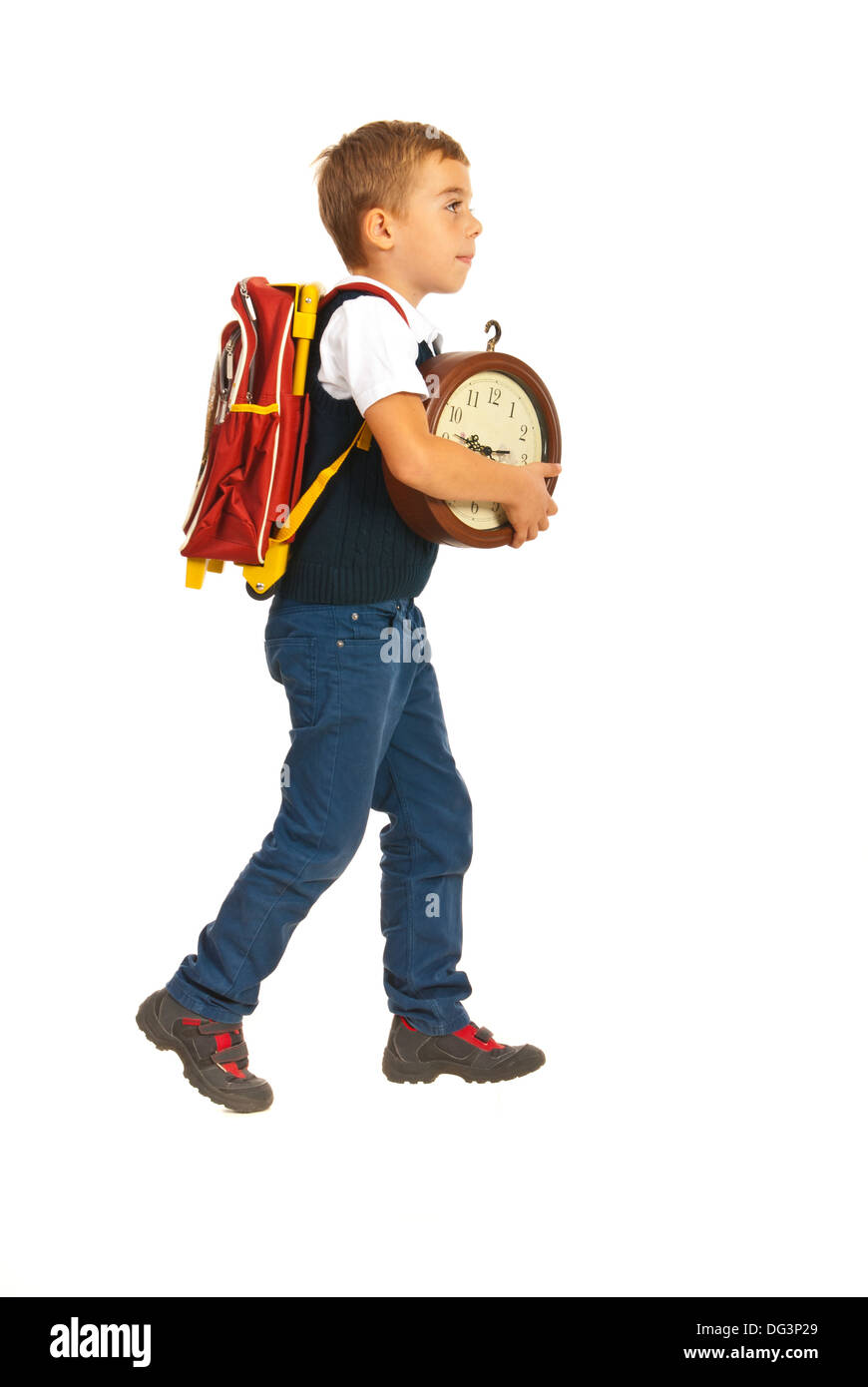 Schoolboy walking to school and holding clock isolated on white background Stock Photo