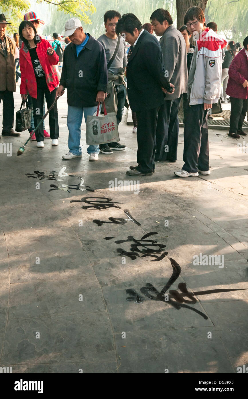 Elderly man writing chinese characters on the pavement summer palace beijing china asia 