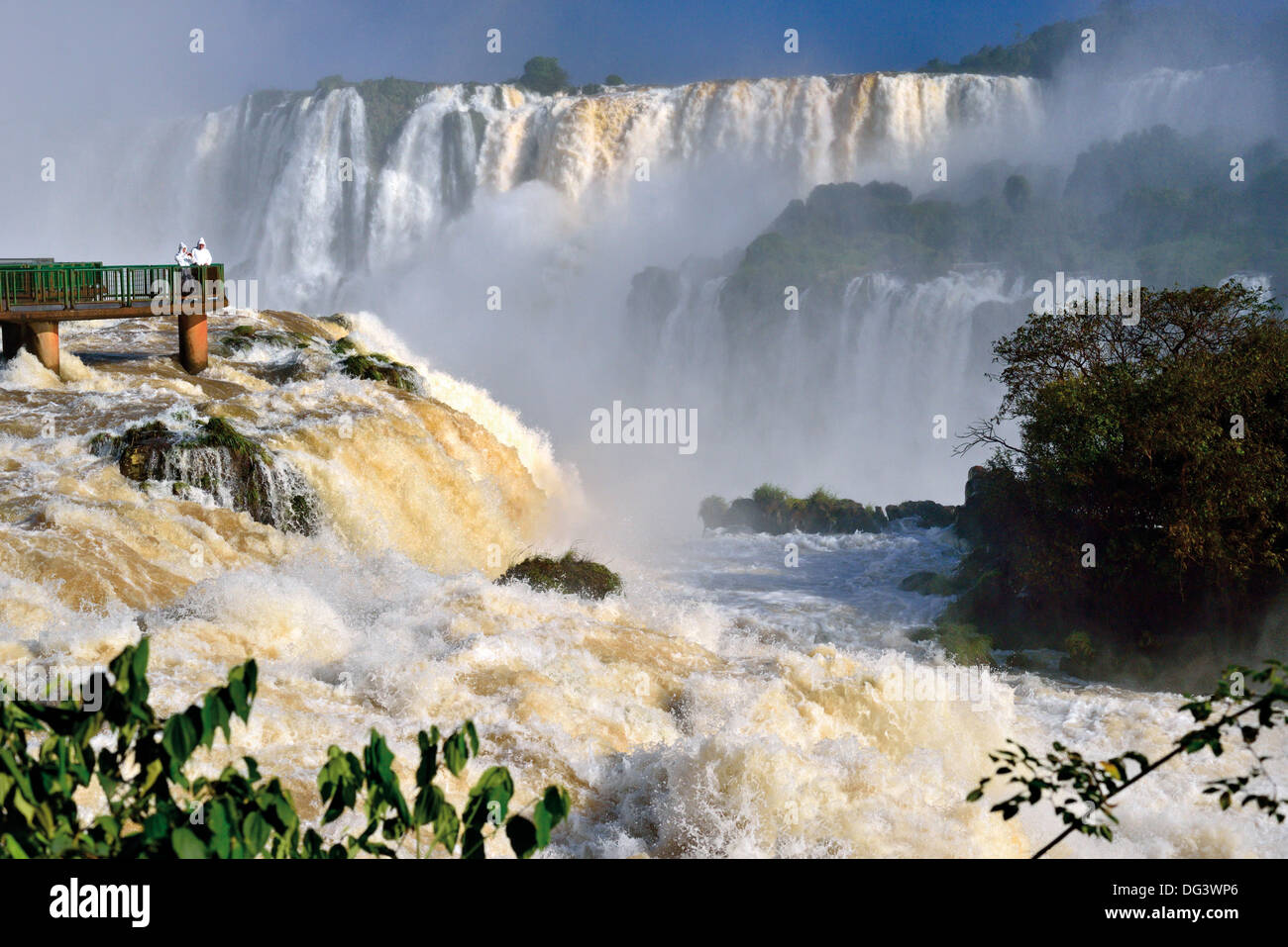 Brazil, Iguassu National Park : Tourists on viewing platform appreciating the enormous water volumes of Iguassu Falls Stock Photo