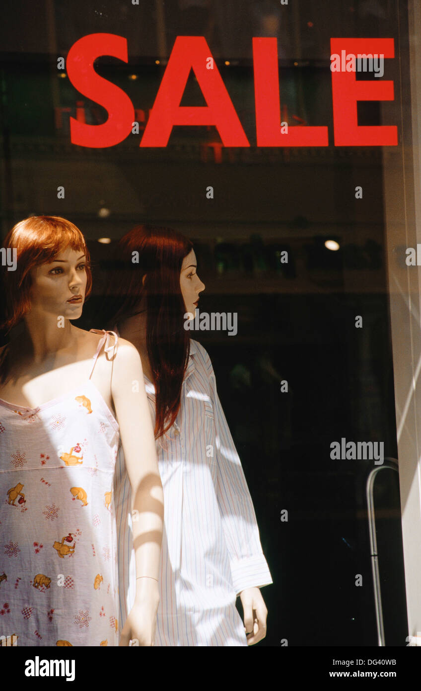 ´Sale´ sign beside dummies in shop window Stock Photo Alamy