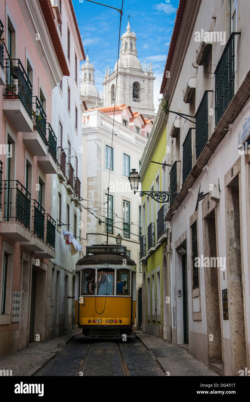 Famous tram 28 going through the old quarter of Alfama, Lisbon