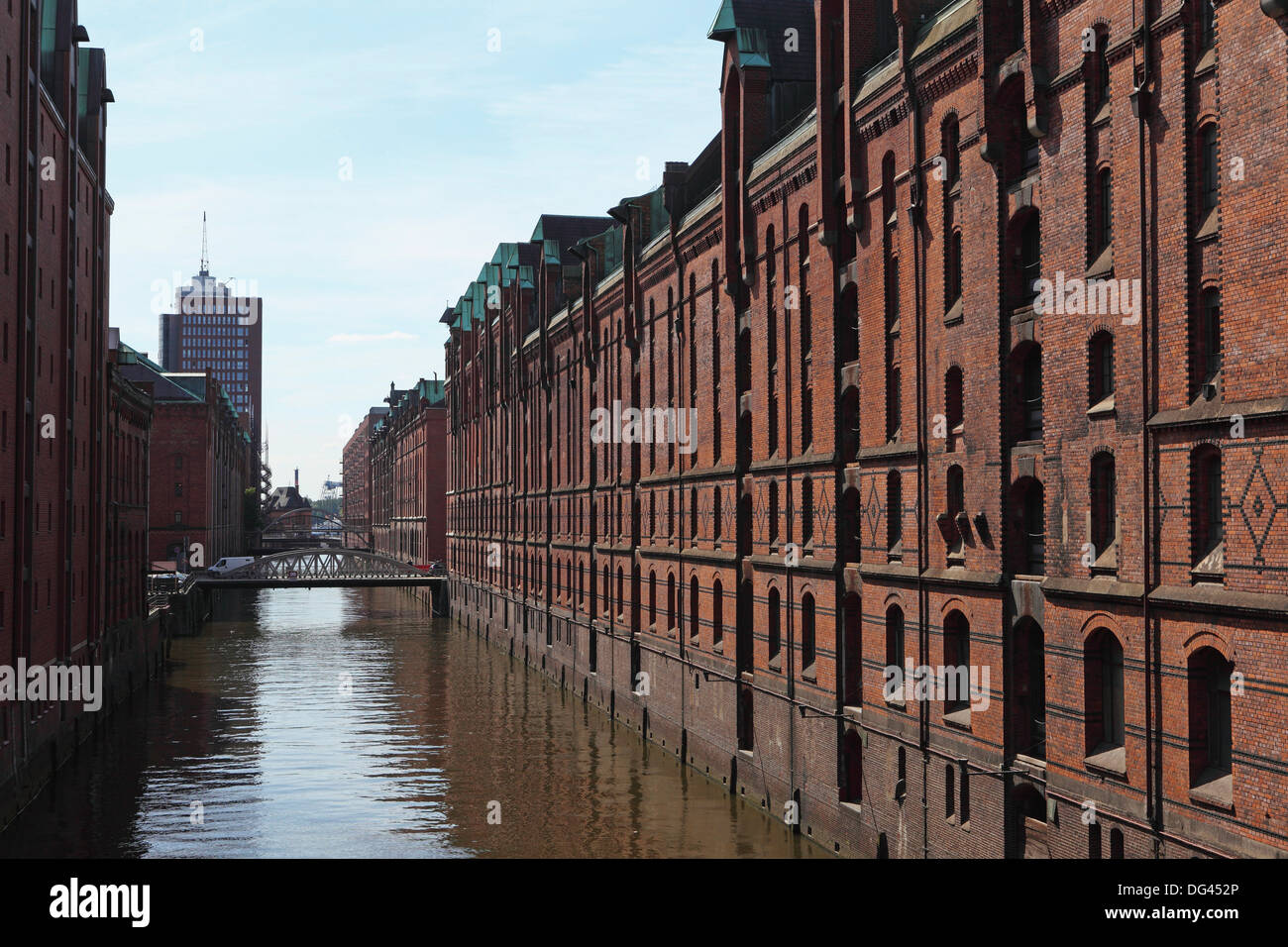 Red brick warehouses overlook a canal in the Speicherstadt district, once a duty free port, in Hamburg, Germany, Europe Stock Photo