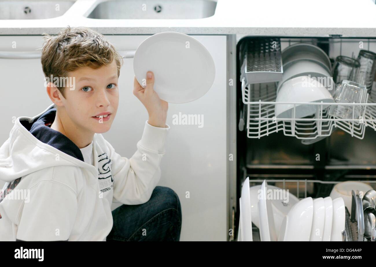 Boy using dishwasher Stock Photo Alamy