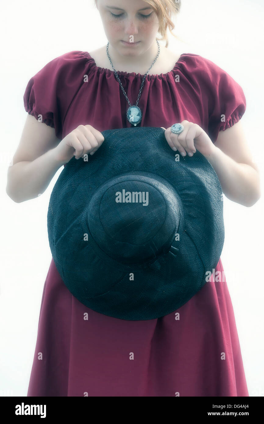 sad young girl with black sunhat Stock Photo