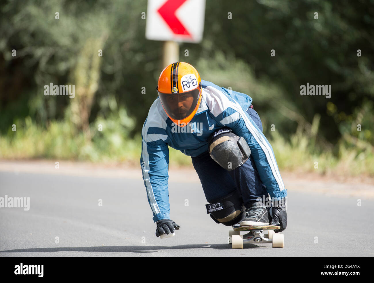 skateboard longboard man training on public road, downhill Stock Photo