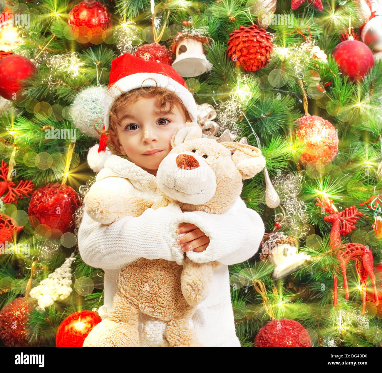 Photo of happy boy holding teddy bear in hands on beautiful decorated ...