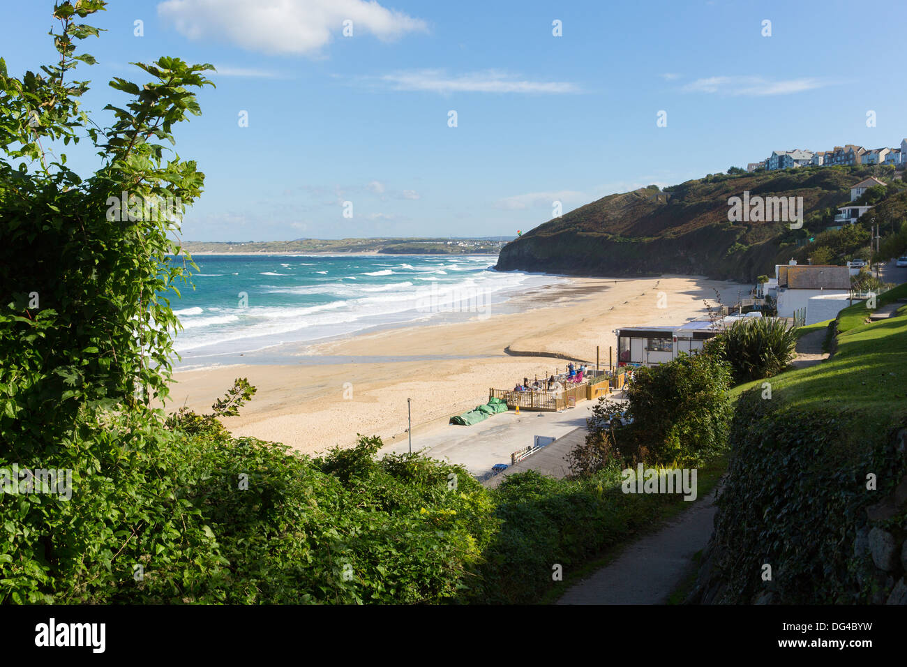 South West Coast Path Carbis Bay Cornwall England near St Ives with a sandy beach and blue sky on a beautiful sunny day Stock Photo