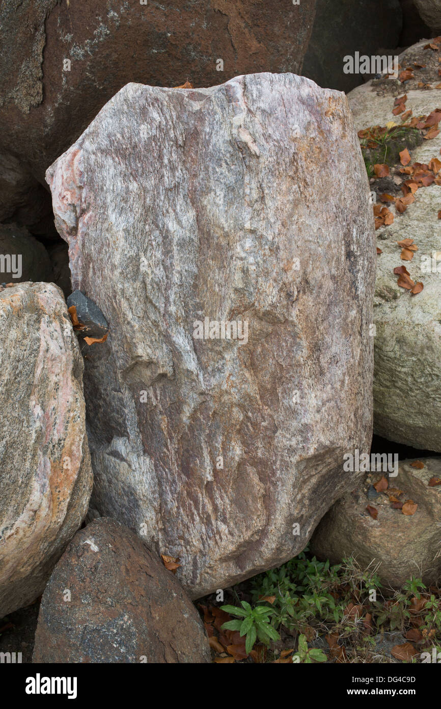 A big rock surrounded by other rocks. Stock Photo
