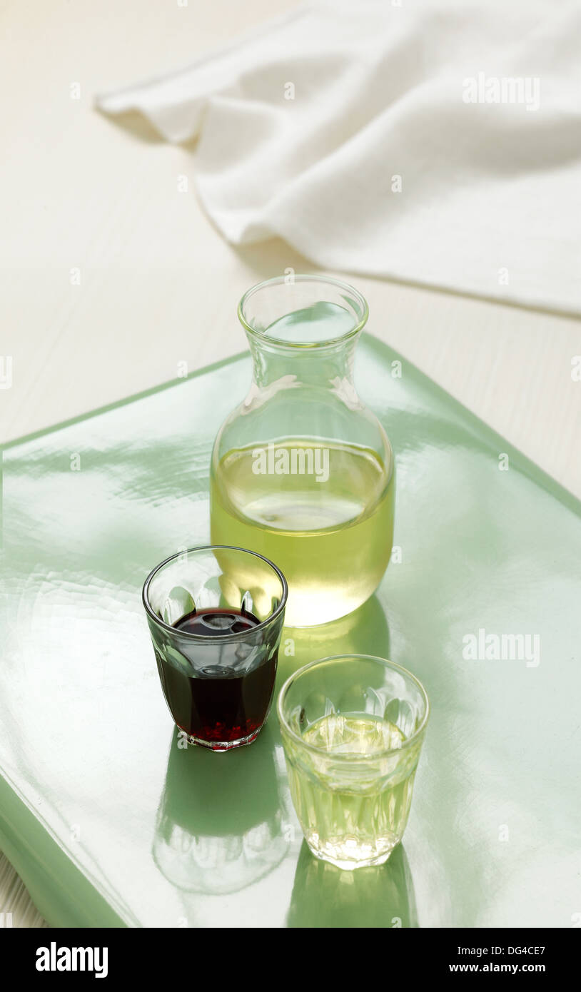 Red & White Wine in glasses sitting alongside a carafe Stock Photo