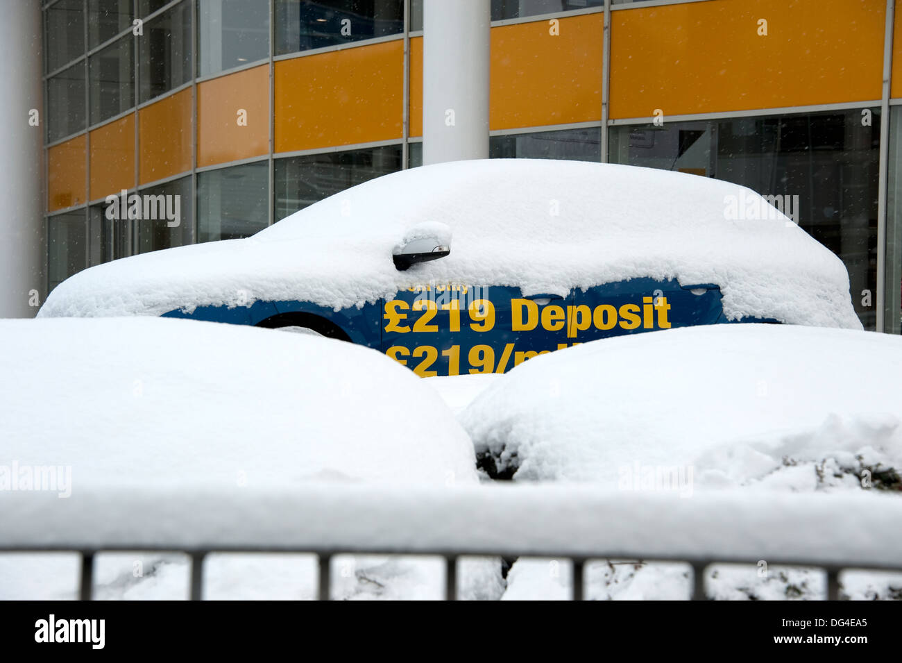 New car for sale covered in deep snow winter frozen Stock Photo