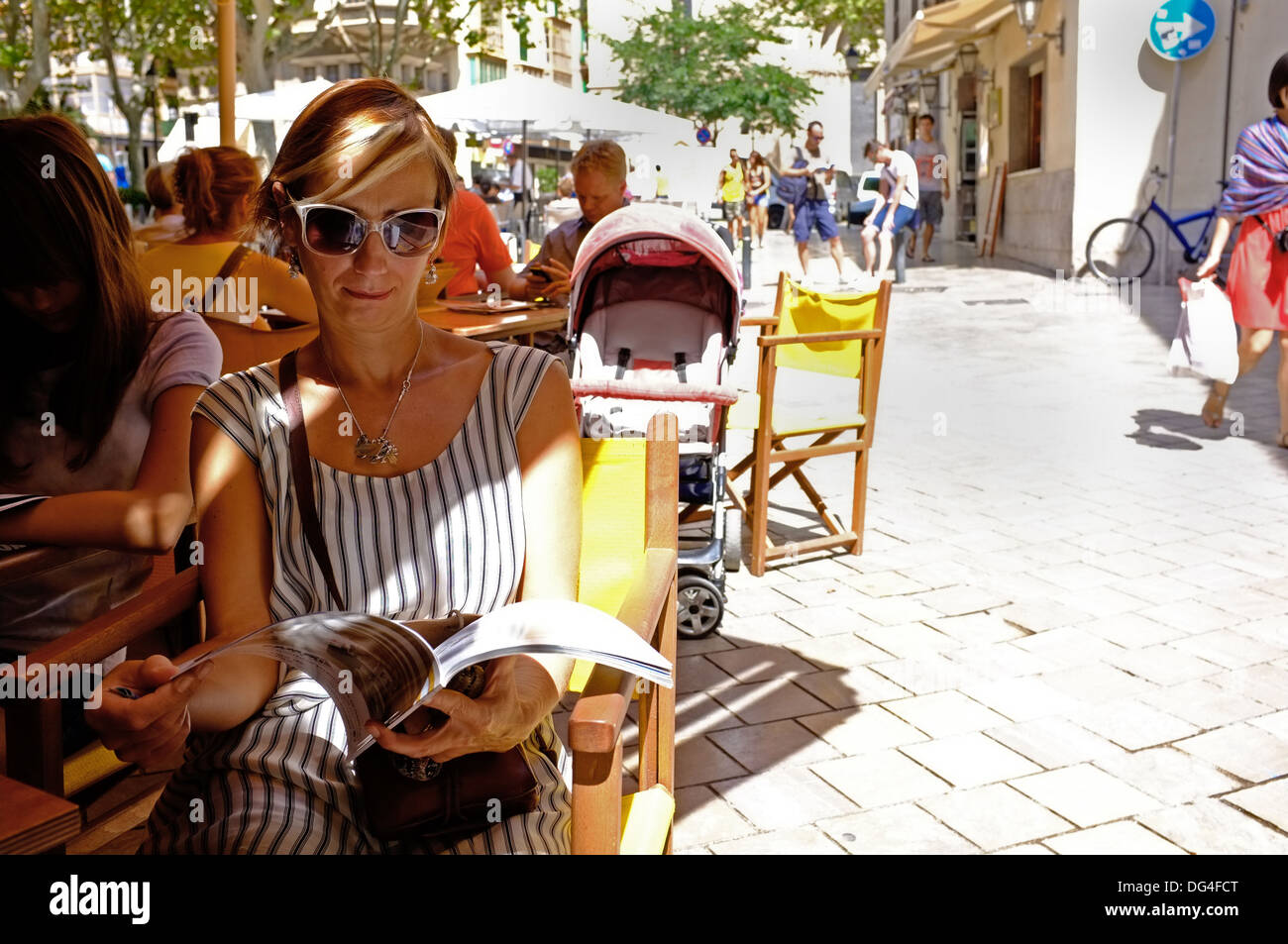 A middle-aged female tourist sitting in a cafe in Palma, Majorca Stock Photo