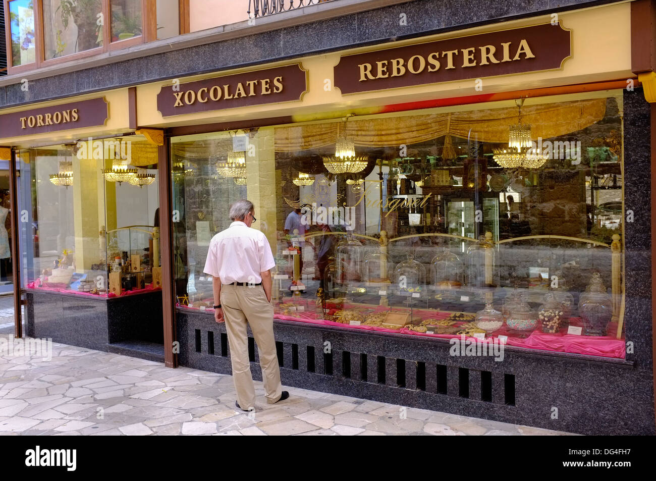 A middle-aged man looking in the window of a cake shop in Palma, Majorca Stock Photo