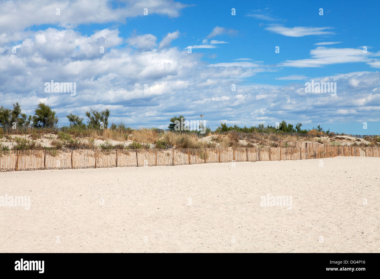 Dunes on the beach with cloudy sunny sky Stock Photo - Alamy