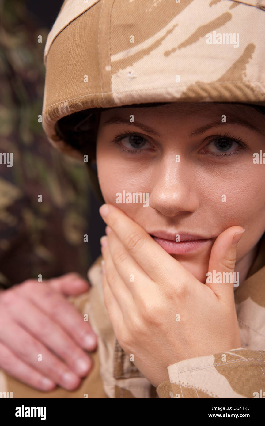 Distraught female soldier being comforted with and hand on the shoulder ...