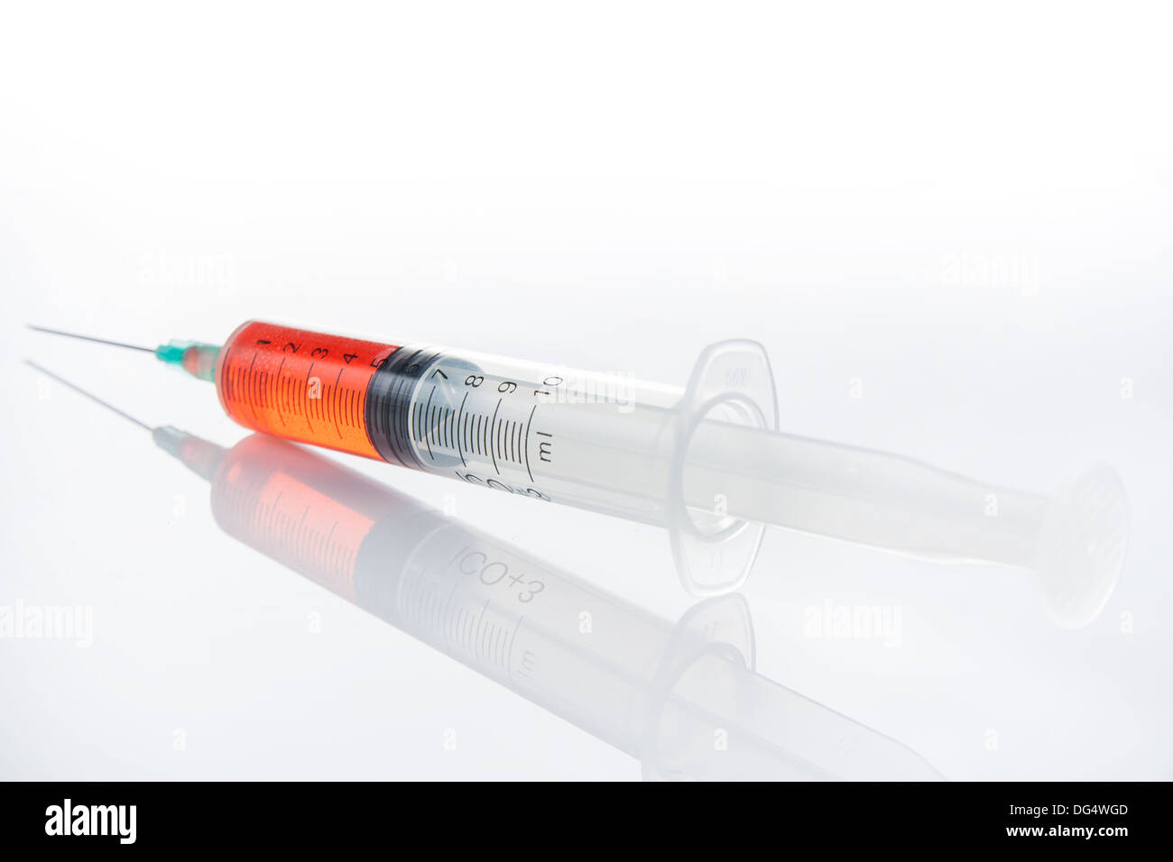 syringe with red fluid on white background Stock Photo