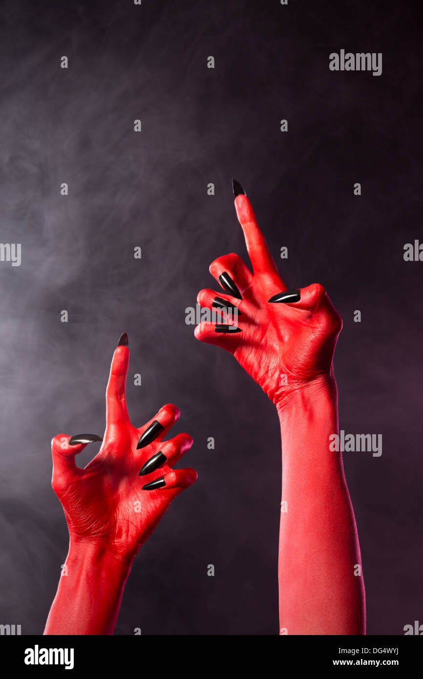 Creepy Red Devil Hands With Black Nails Halloween Theme Stock Photo Alamy