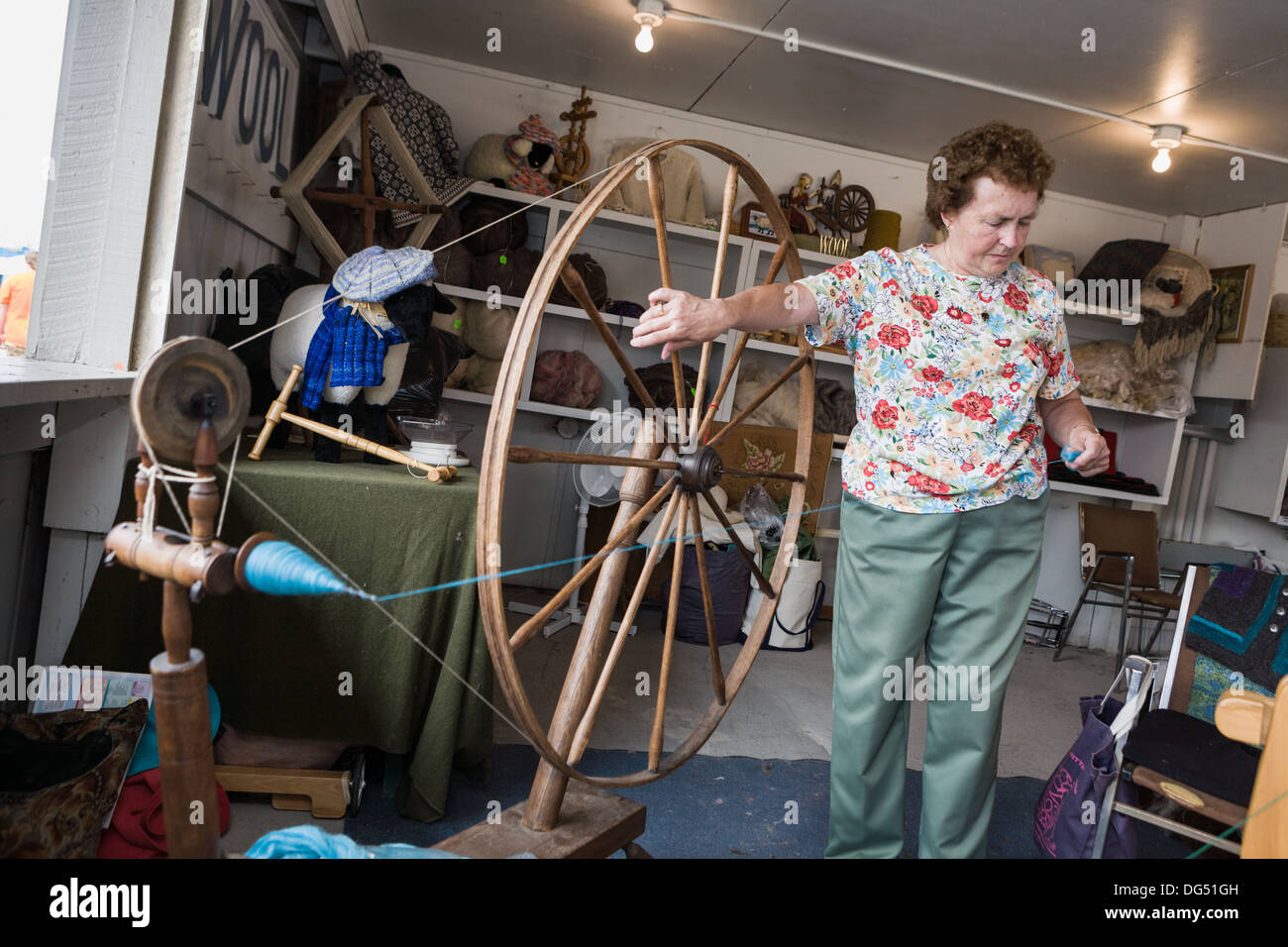 Woman demonstrates spinning wheel, Great New York State Fair, Syracuse