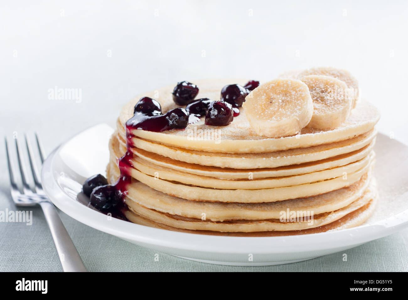 pancakes with blueberries and banana on white plate Stock Photo