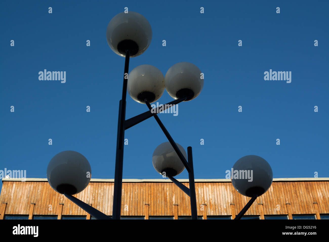 Light post in front of wood panelled building in design from the fifties in Vallingby City, suburb west of Stockholm, Sweden. Stock Photo