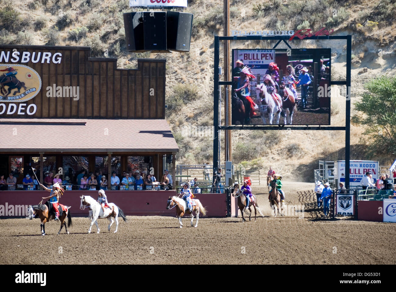 Indian tribespeople on horseback enter the arena grounds at the
