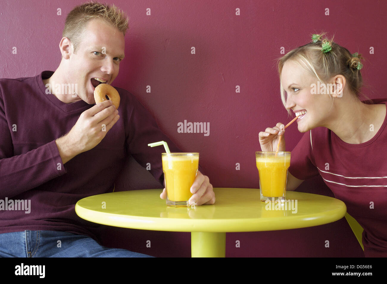 Couple Drinking Orange Juice Stock Photo Alamy