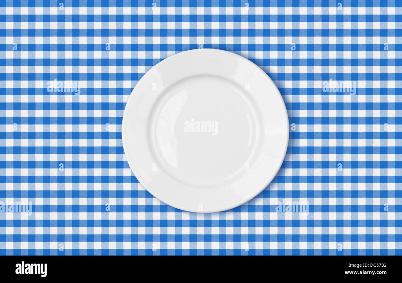 table with blue picnic cloth and plate top view Stock Photo