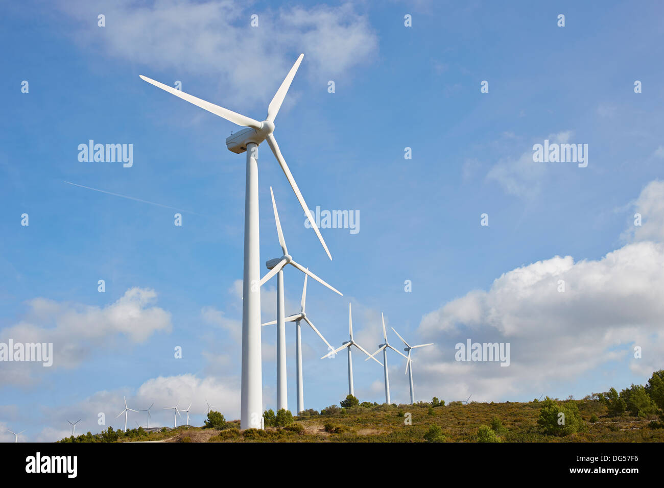 Group of windmills for renewable electric energy production on blue sky Stock Photo