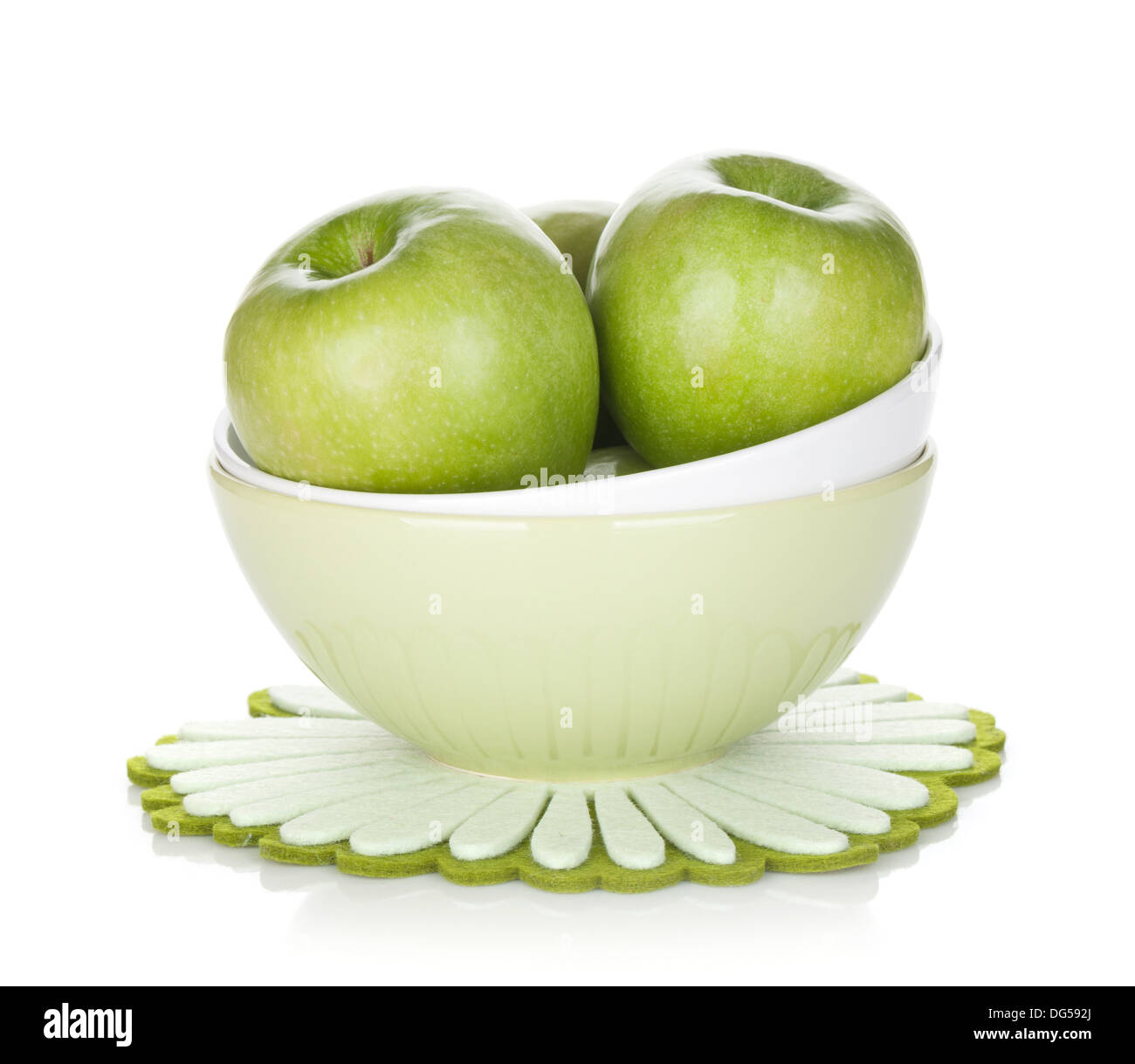 Green apples in fruit bowl. Isolated on white background Stock Photo