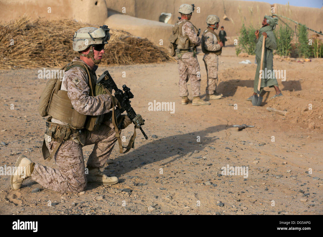 US Marines with Alpha company, 9th Marine Regiment search a village during a foot patrol October 12, 2013 in Helmand province, Afghanistan. Stock Photo