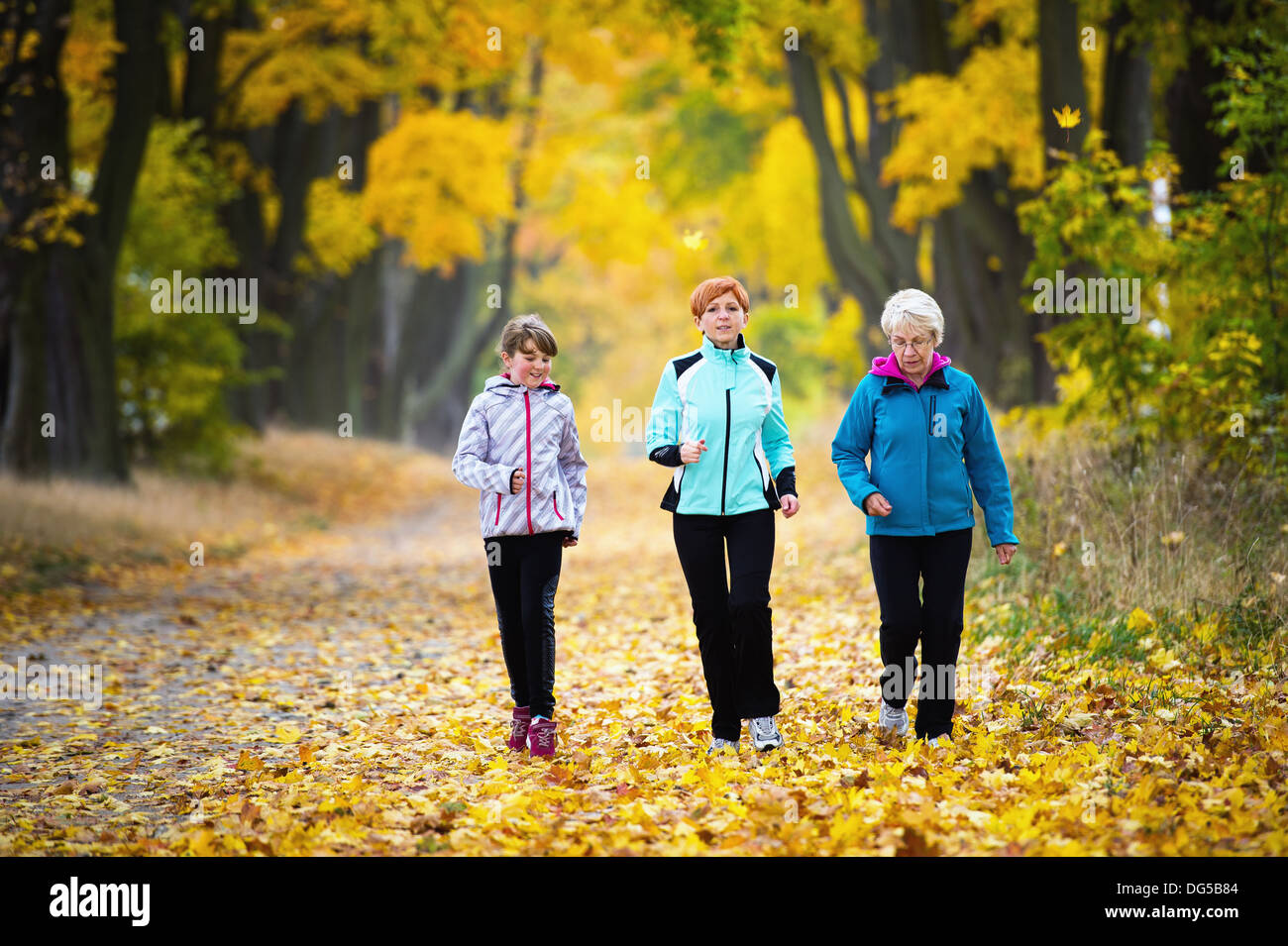 Three generations of women running in park Stock Photo