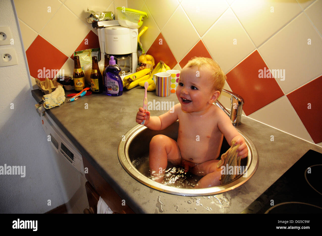 A Baby Having His Bath And Scrubbing His Teeth In The