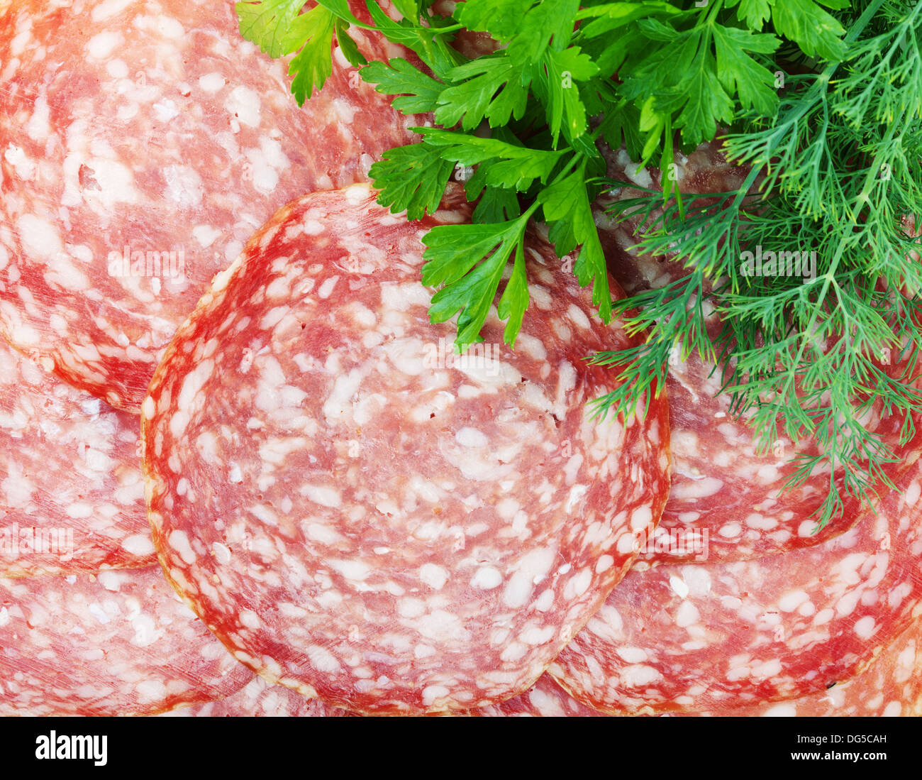 Sliced salami detail texture and herbs Stock Photo Alamy