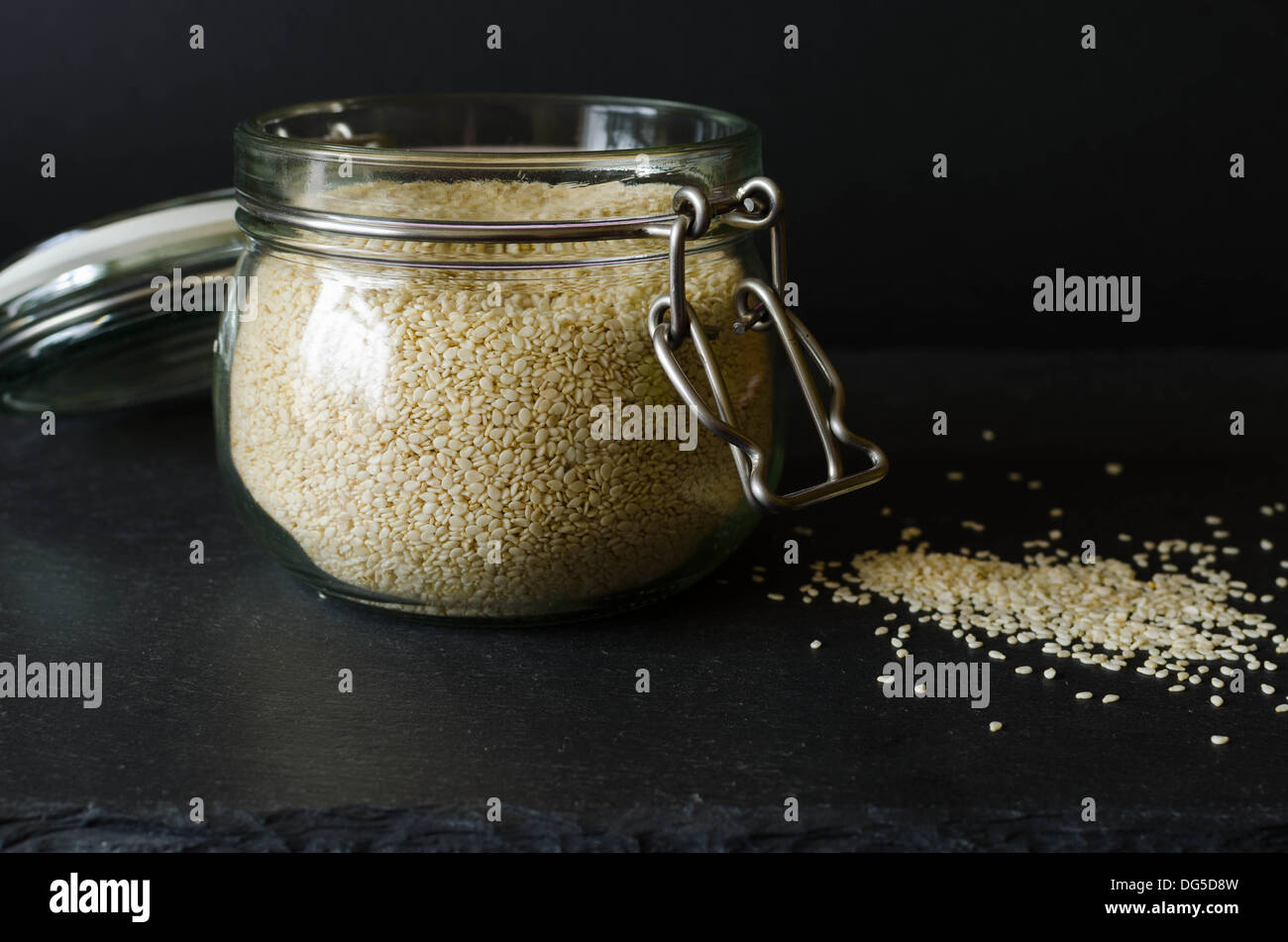 Sesame seed in a jar, black background Stock Photo Alamy