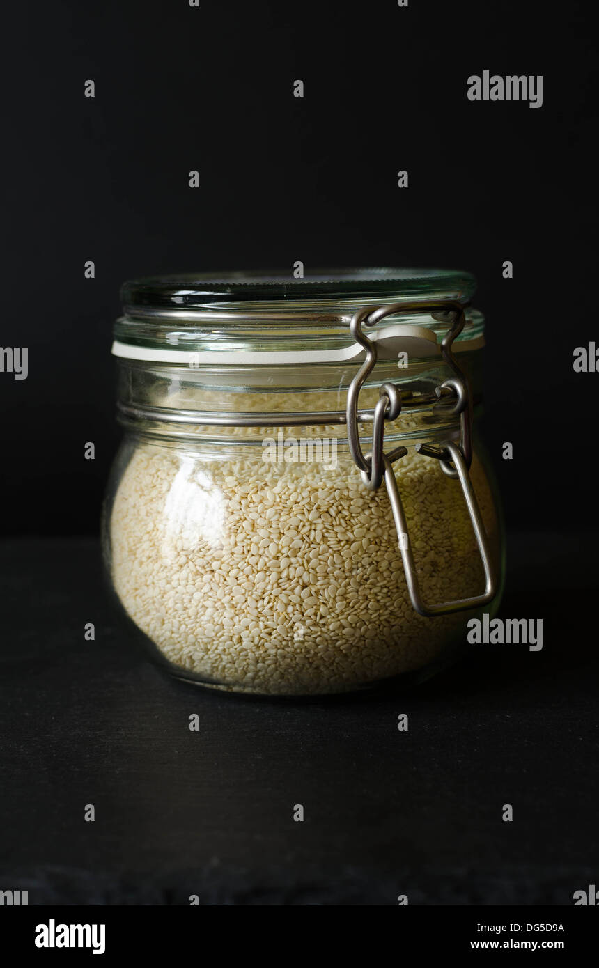 Sesame seed in a jar, black background Stock Photo Alamy