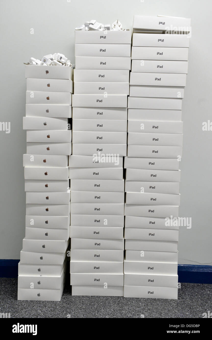 Lots of boxes of Apple iPad's and chargers stacked up Stock Photo