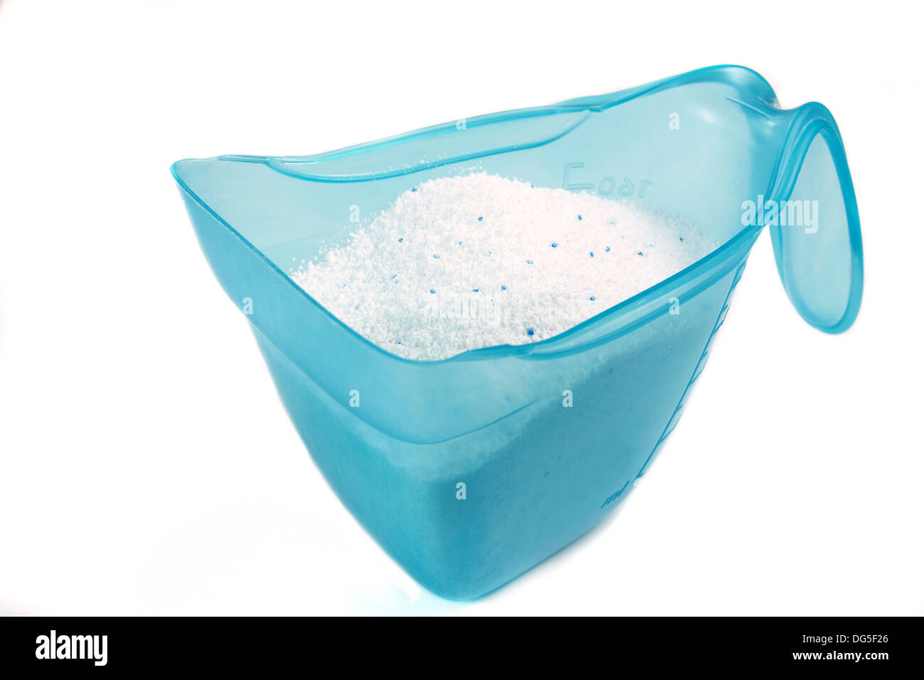 Laundry detergent or washing powder in a blue measuring cup studio