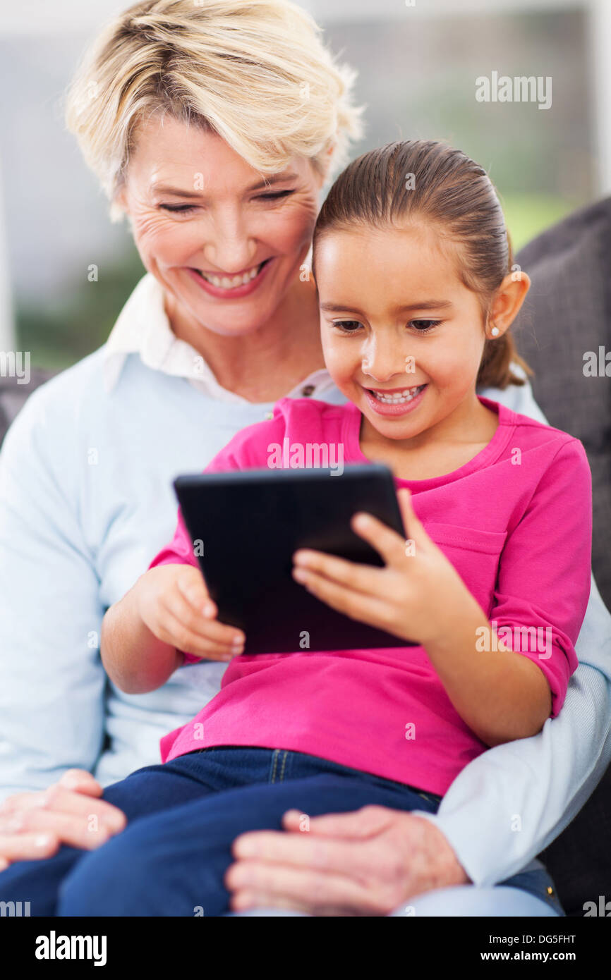cute little girl using tablet pc with grandma at home Stock Photo - Alamy