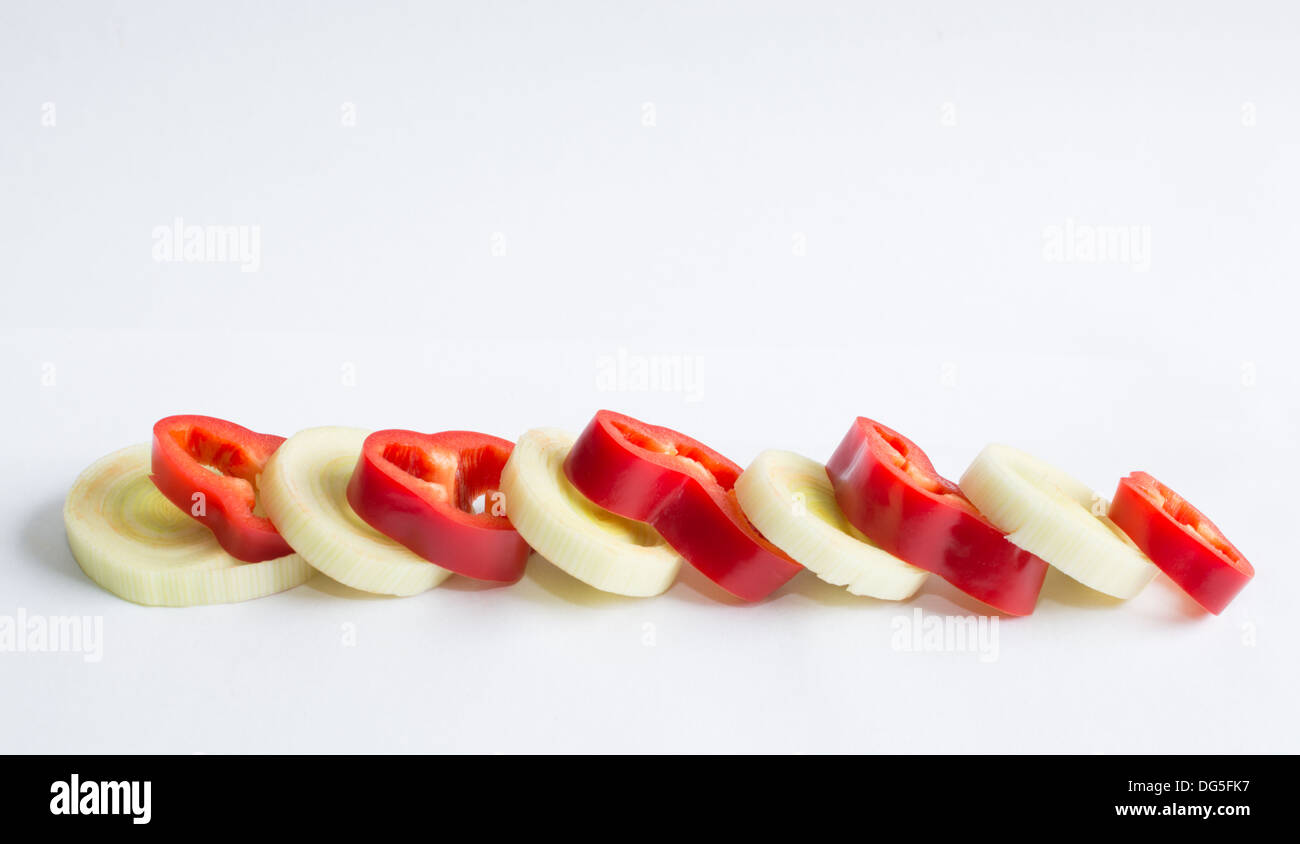 Sliced onion and red paprika in a row. Stock Photo