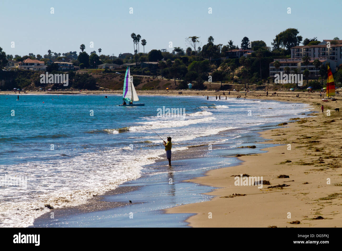 Beach scene in Santa Barbara, California with man surf
