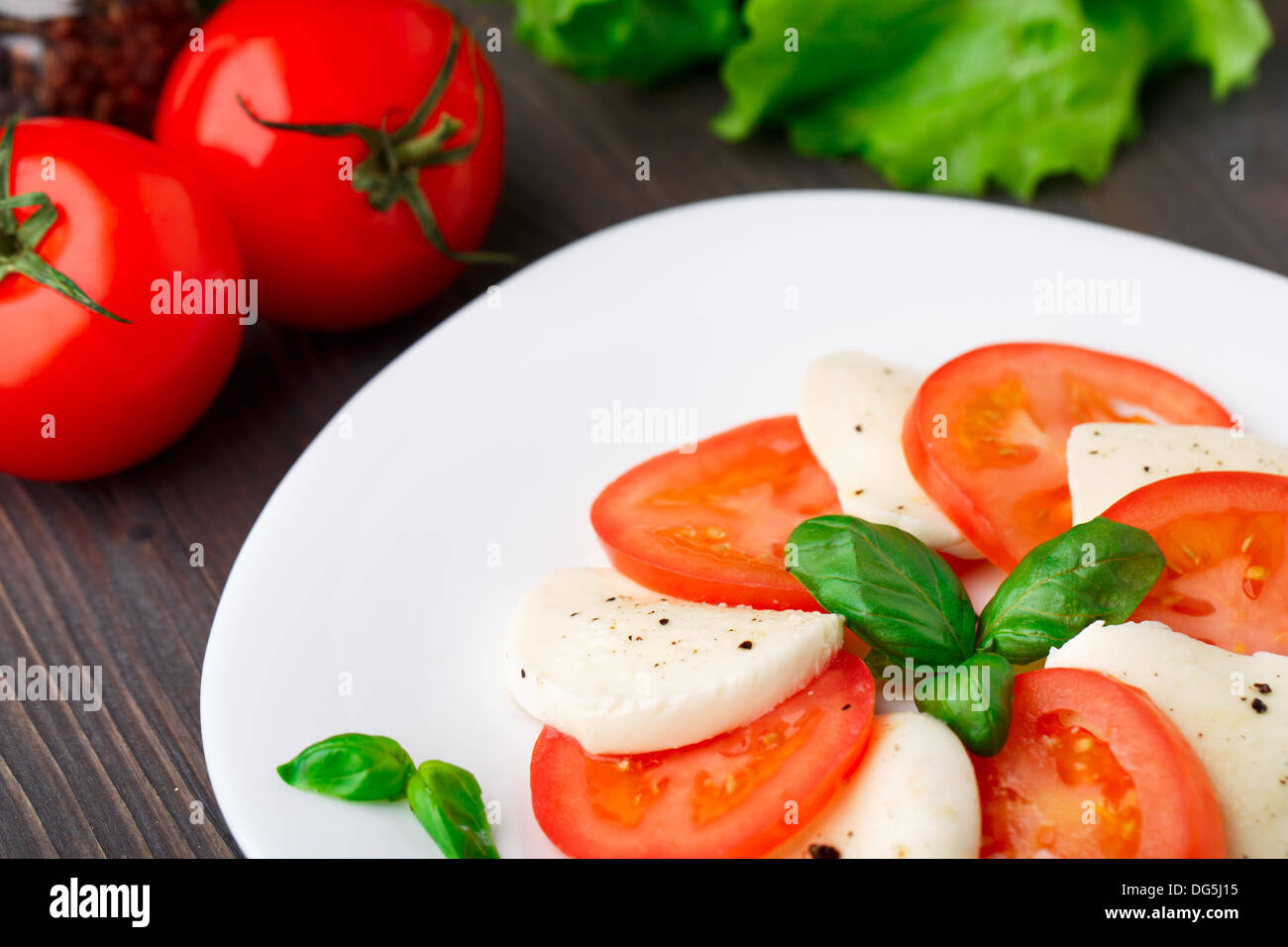 Tomato and mozzarella with basil leaves Stock Photo - Alamy