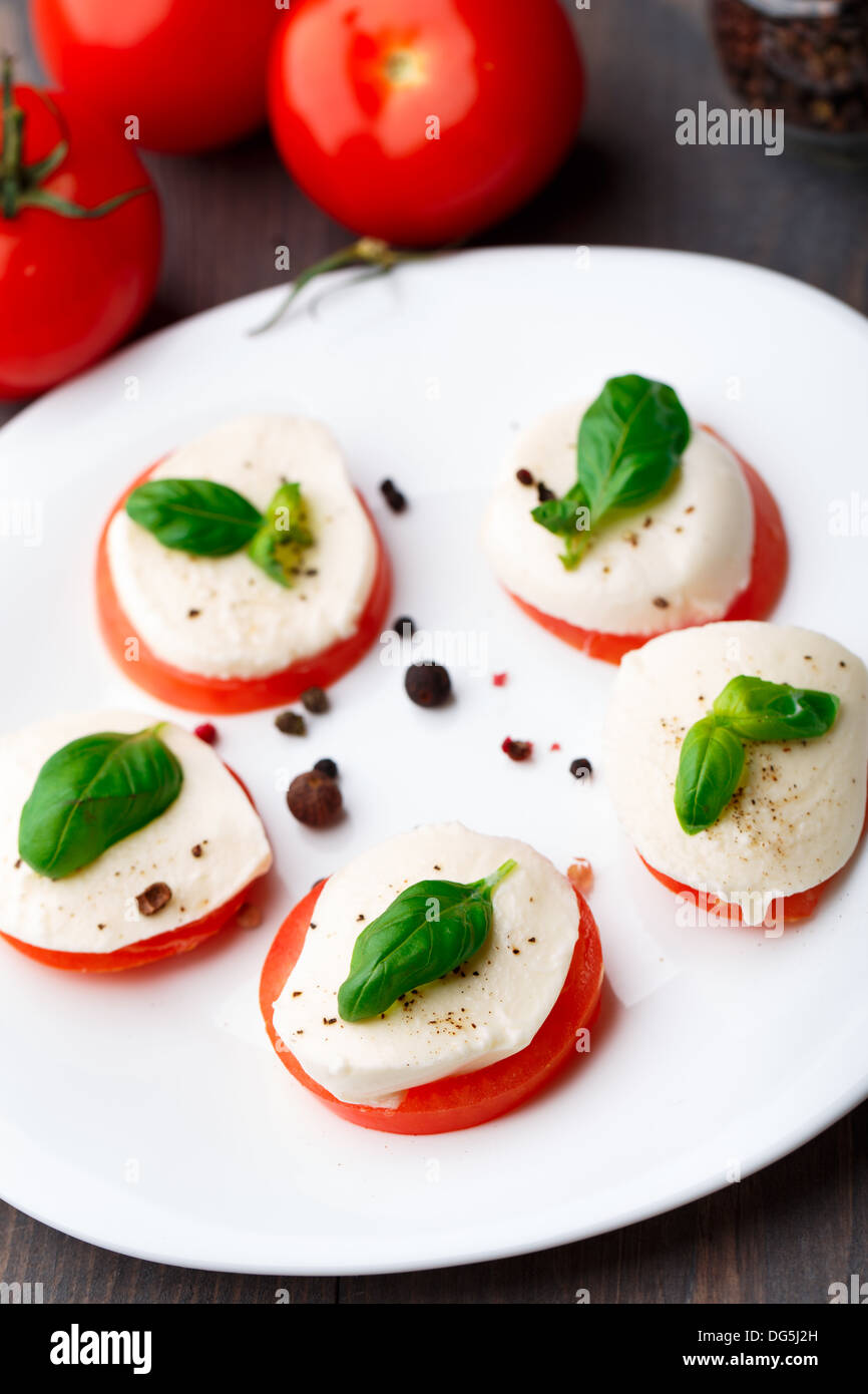 Tomato and mozzarella with basil leaves Stock Photo - Alamy