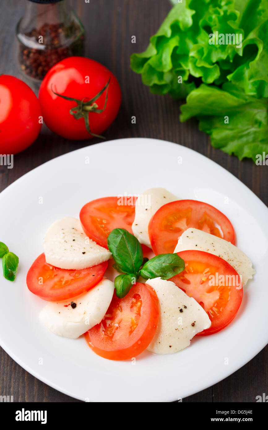 Tomato and mozzarella with basil leaves Stock Photo - Alamy