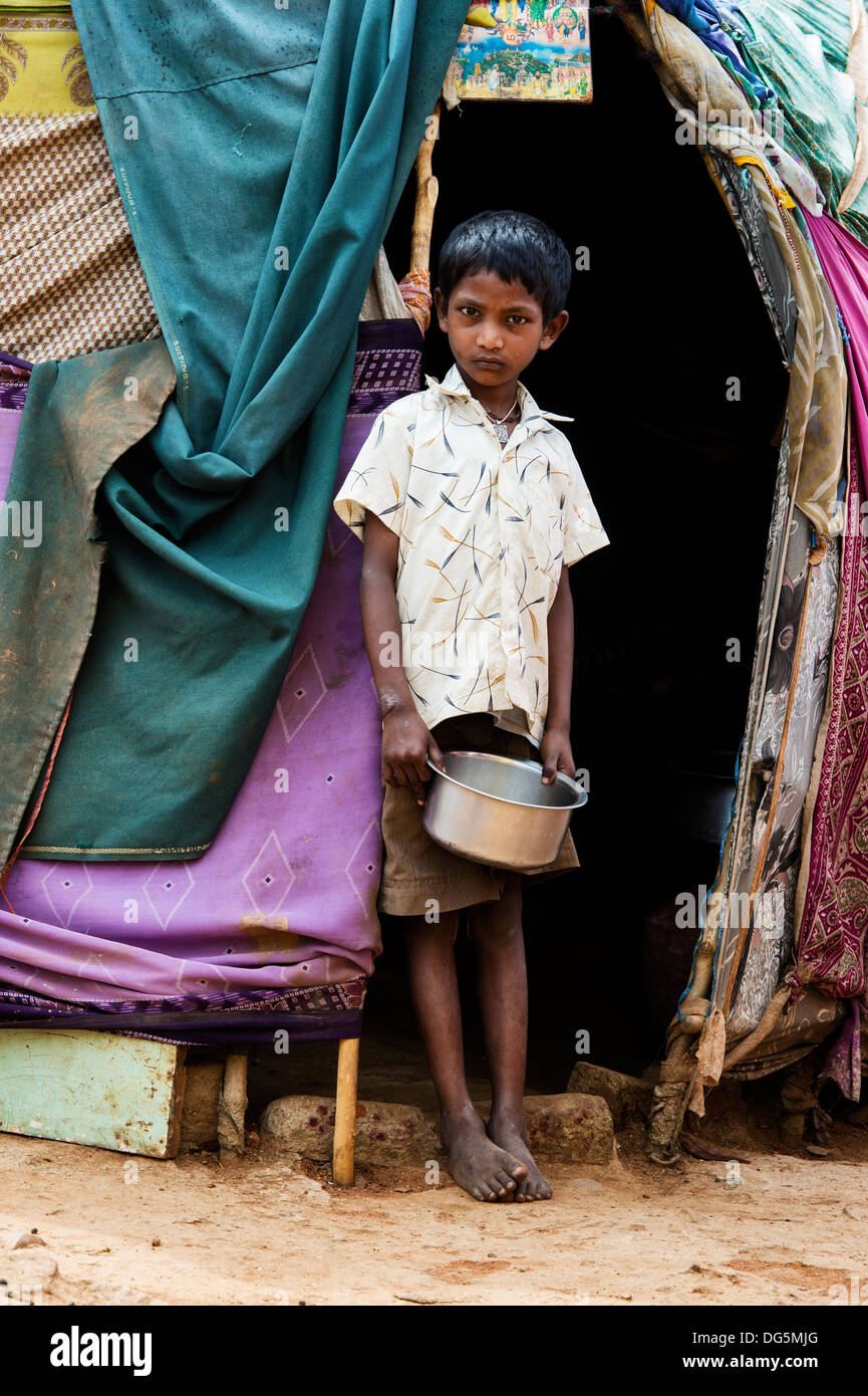 Indian lower caste boy standing outside his bender / tent / shelter
