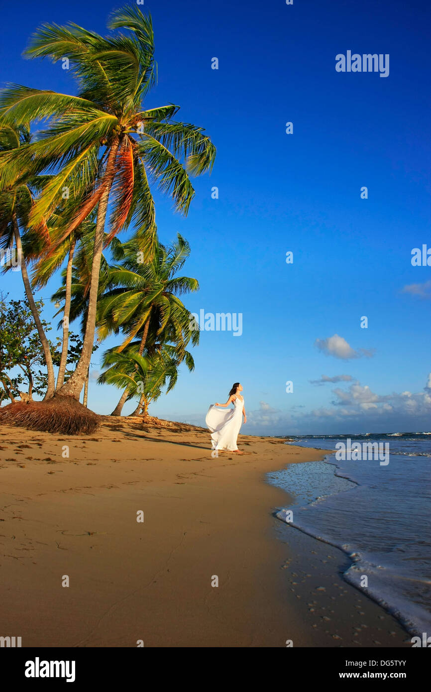 Young woman in white dress on a beach Stock Photo - Alamy