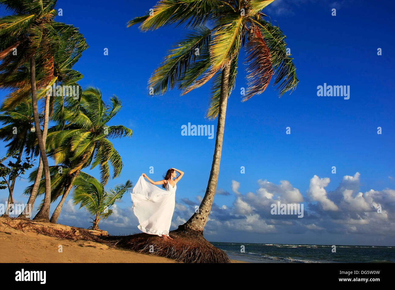Young woman in white dress on a beach Stock Photo - Alamy
