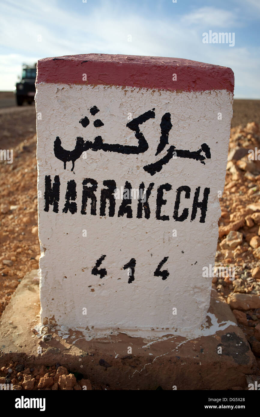 Milestone along the 'Erg Chigaga' desert road, leading to Marrakesh. Western Sahara desert, Morocco. Stock Photo