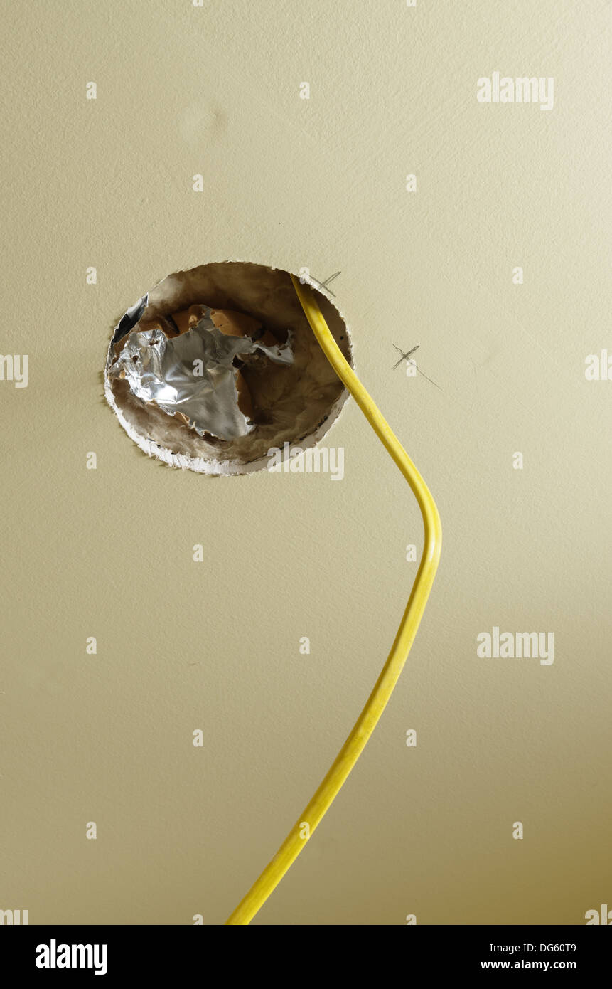 hole in drywall for a ceiling light installation during a home remodel Stock Photo