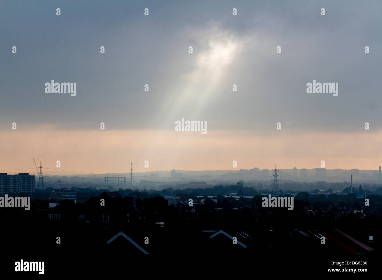 London, UK. 15th Oct, 2013. A beam of light breaks through the clouds shining down on Wimbledon town south west London Credit:  amer ghazzal/Alamy Live News Stock Photo