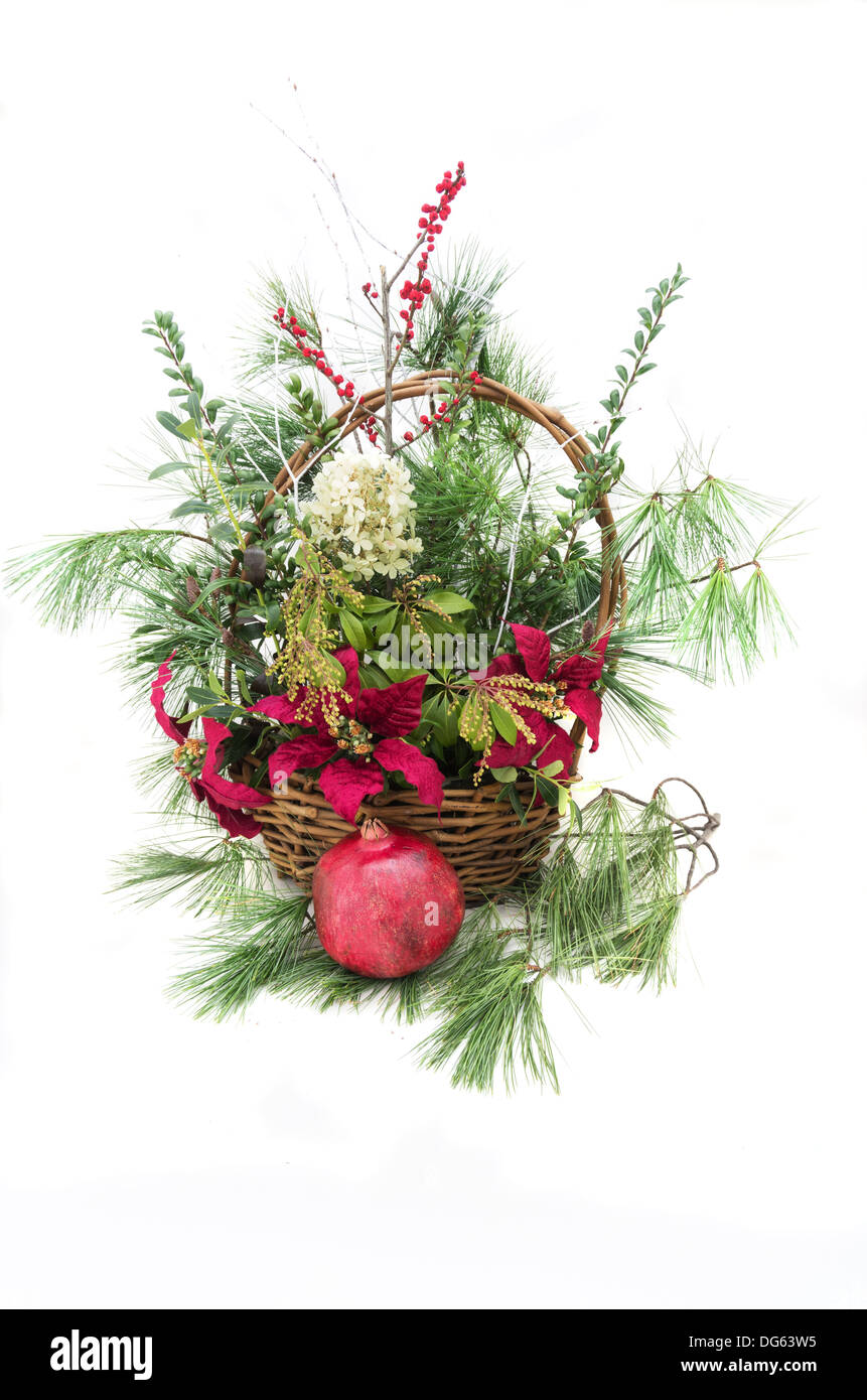 Christmas arrangement in a basket with greenery and flowers Stock Photo