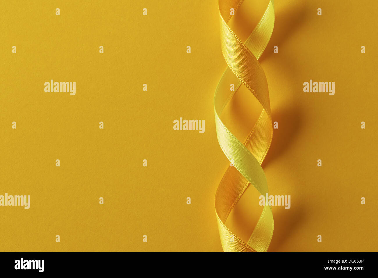 Two twisted yellow ribbons wallpaper Stock Photo - Alamy